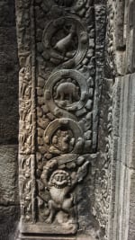 A carved relief that is part of the columns adjacent to one of the many doors of the Ta Prohm temple.